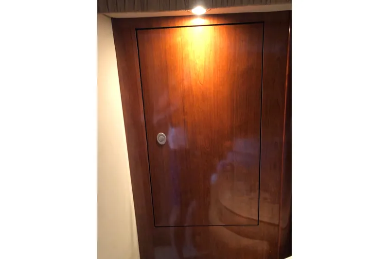 Slide: The Image of Wooden cabin door on 2004 Sea Ray 420 Sundancer yacht, illuminated by overhead light. - 22