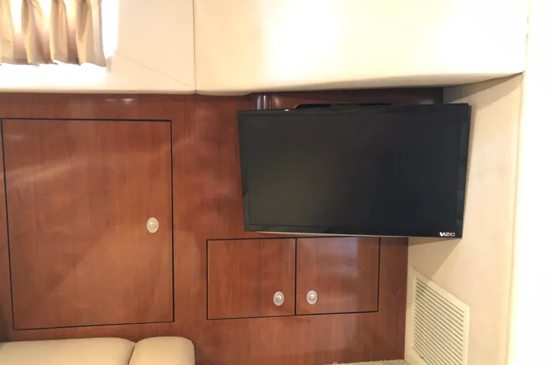 Slide: The Image of Interior of 2004 Sea Ray 420 Sundancer with mounted Vizio TV and wooden cabinetry. - 26