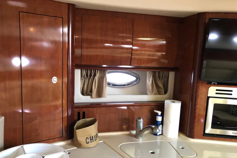 Slide: The Image of Luxurious interior of 2004 Sea Ray 420 Sundancer yacht with wood cabinetry and modern amenities. - 24