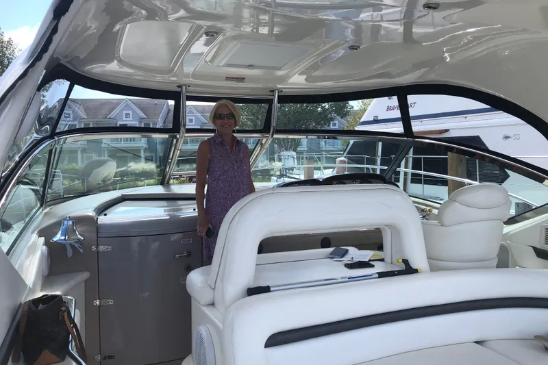 Slide: The Image of Woman standing inside a 2004 Sea Ray 420 Sundancer yacht, showcasing luxurious interior. - 11