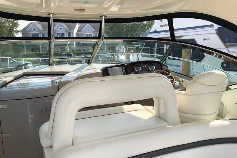 Slide: The Image of Interior view of 2004 Sea Ray 420 Sundancer yacht cockpit with luxurious seating and controls. - 13