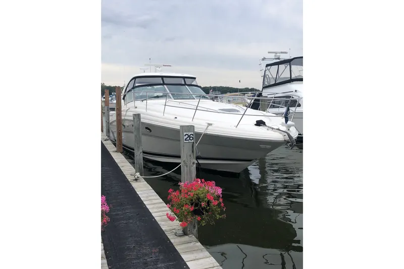Slide: The Image of 2004 Sea Ray 420 Sundancer docked at marina with flowers nearby. - 4