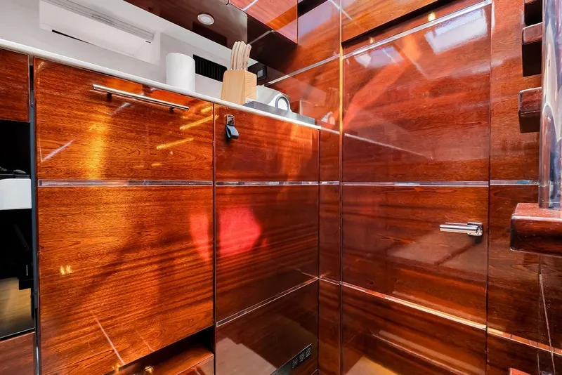 Slide: The Image of Luxurious wooden interior of a 2021 Steeler 60S yacht kitchen with sleek cabinetry. - 90