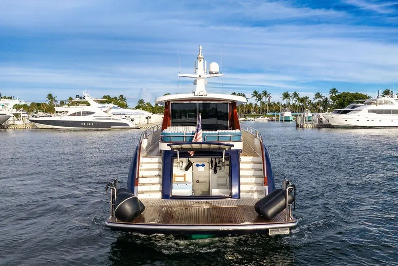 Slide: The Image of Steeler 60S 2021 yacht cruising in a marina with palm trees and other boats. - 47