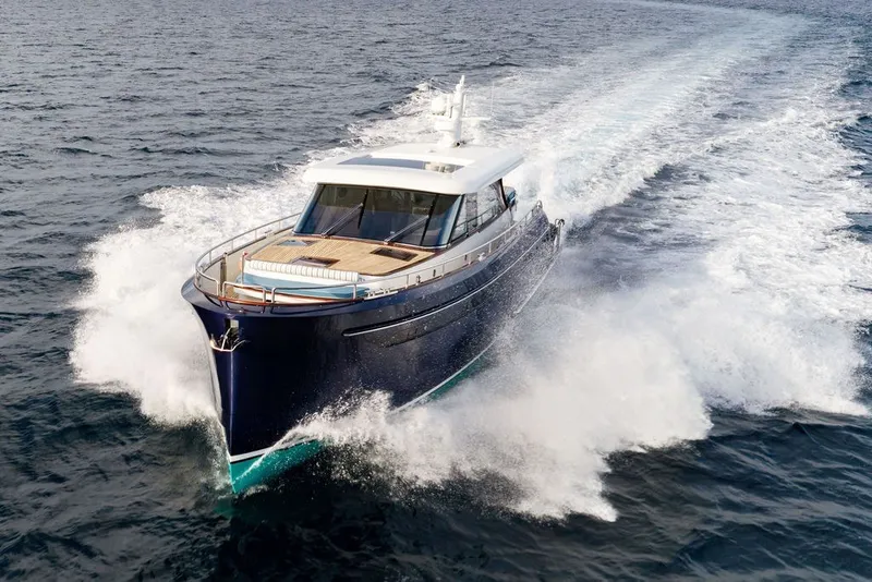 Slide: The Image of Steeler 60S 2021 yacht cruising swiftly on open water, creating a dynamic wake. - 27