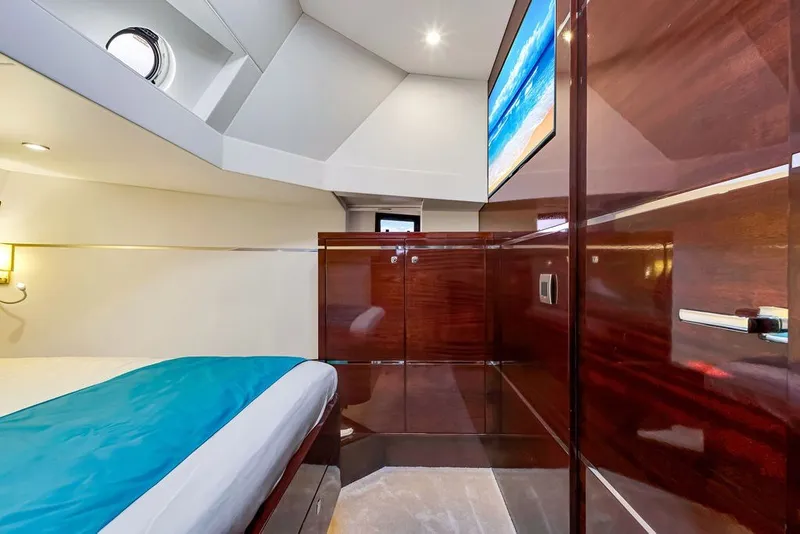 Slide: The Image of Luxurious cabin interior of 2021 Steeler 60S yacht with modern wood finishes and TV. - 96