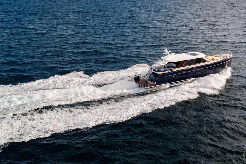 Slide: The Image of Luxurious 2021 Steeler 60S yacht cruising on open sea, leaving a trail of white waves. - 32