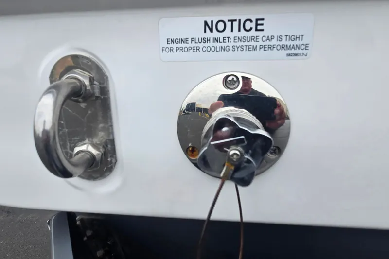 Slide: The Image of 2025 Malibu Wakesetter 23 LSV engine flush inlet with notice for cooling system maintenance. - 22