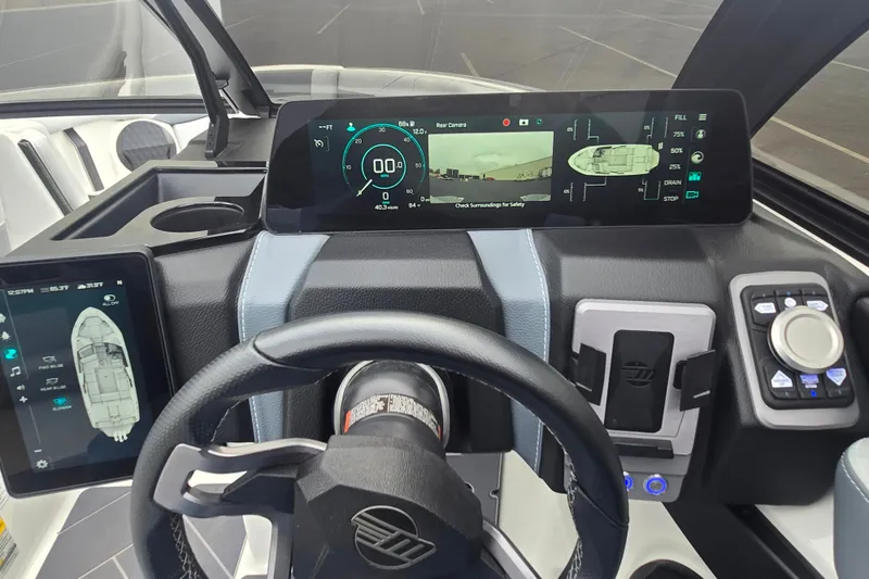 Slide: The Image of 2025 Malibu Wakesetter 23 LSV dashboard with advanced digital controls and steering wheel. - 15