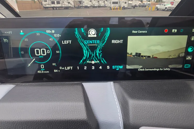 Slide: The Image of Dashboard of 2025 Malibu Wakesetter 23 LSV with digital display and rear camera view. - 13