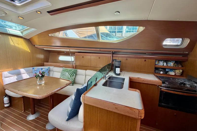 Slide: The Image of Interior of 2007 Jeanneau Sun Odyssey 42 DS yacht with cozy seating and kitchen area. - 40