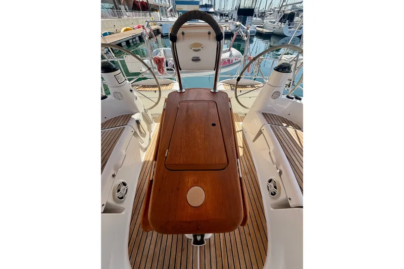 Slide: The Image of Cockpit view of 2007 Jeanneau Sun Odyssey 42 DS sailboat with wooden table and steering wheel. - 26