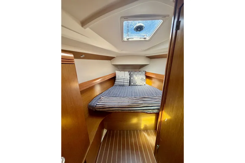 Slide: The Image of Cozy cabin interior of 2007 Jeanneau Sun Odyssey 42 DS sailboat with striped bedding. - 64