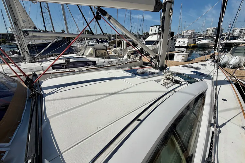Slide: The Image of 2007 Jeanneau Sun Odyssey 42 DS sailboat docked in a marina, surrounded by other boats. - 5