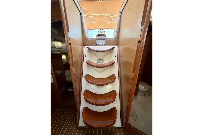 Slide: The Image of Interior stairs of 2007 Jeanneau Sun Odyssey 42 DS sailboat, featuring wooden steps. - 94