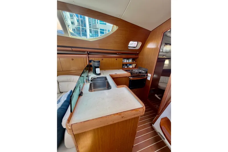Slide: The Image of Interior of 2007 Jeanneau Sun Odyssey 42 DS yacht kitchen with wood finish and appliances. - 47