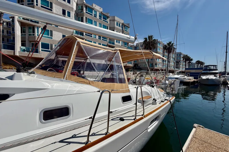 Slide: The Image of 2007 Jeanneau Sun Odyssey 42 DS sailboat docked in a marina, with modern buildings in the background. - 15