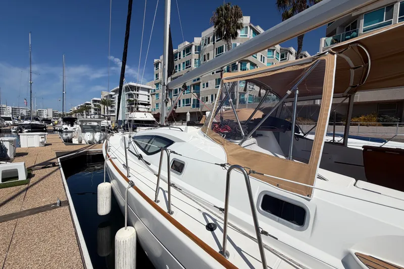Slide: The Image of 2007 Jeanneau Sun Odyssey 42 DS sailboat docked at marina with modern buildings. - 17