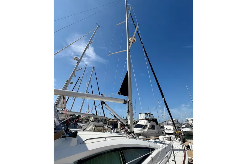 Slide: The Image of 2007 Jeanneau Sun Odyssey 42 DS sailboat with mast, docked in marina under clear blue sky. - 7