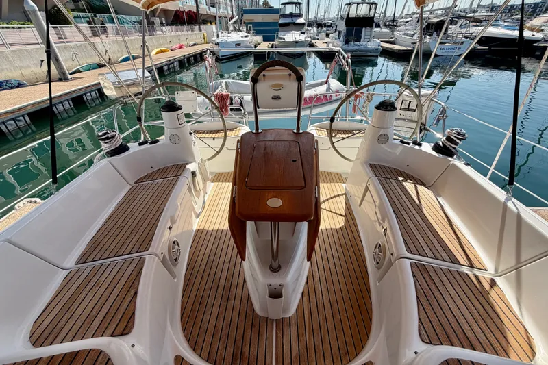 Slide: The Image of Cockpit of 2007 Jeanneau Sun Odyssey 42 DS yacht in marina, featuring dual steering wheels. - 25