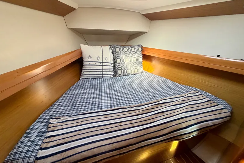 Slide: The Image of Cozy cabin interior of 2007 Jeanneau Sun Odyssey 42 DS with striped bedding. - 79