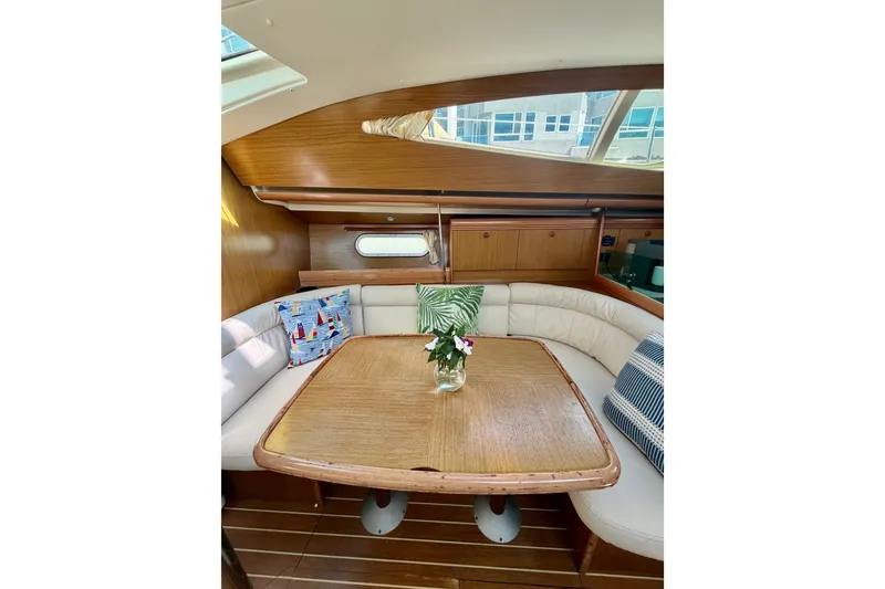 Slide: The Image of Cozy interior of 2007 Jeanneau Sun Odyssey 42 DS with elegant wood finish and plush seating. - 91