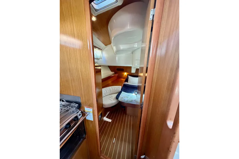Slide: The Image of Interior of 2007 Jeanneau Sun Odyssey 42 DS sailboat, featuring cozy cabin and wooden finishes. - 51