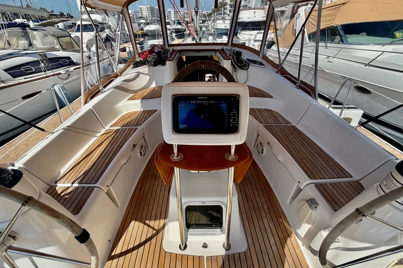 Slide: The Image of 2007 Jeanneau Sun Odyssey 42 DS cockpit with wooden seating and navigation equipment. - 28