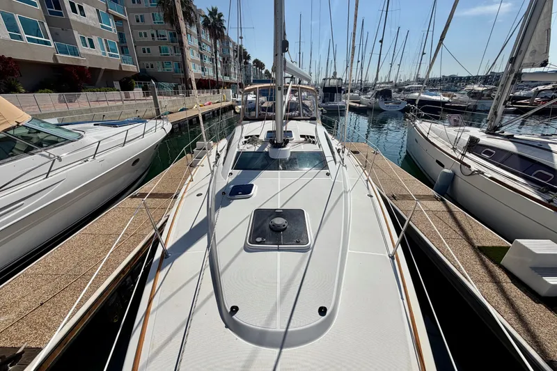 Slide: The Image of 2007 Jeanneau Sun Odyssey 42 DS sailboat docked at marina, surrounded by other boats. - 10