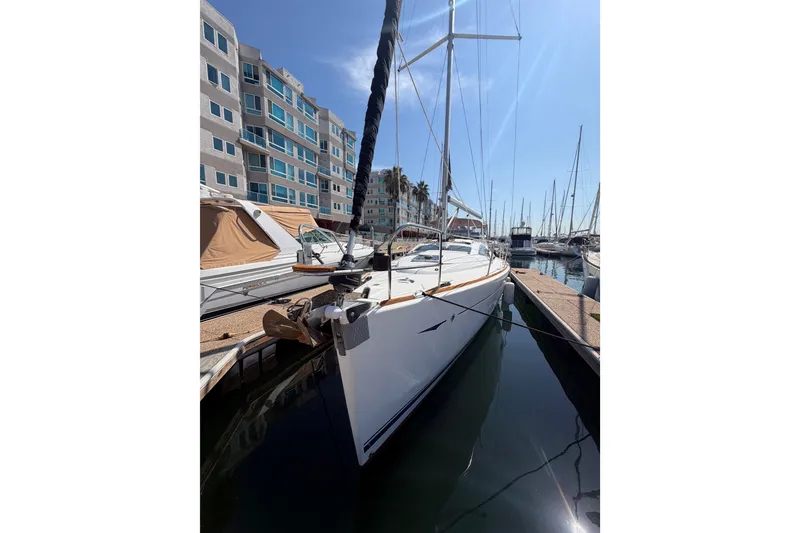 Slide: The Image of 2007 Jeanneau Sun Odyssey 42 DS sailboat docked in marina under clear blue sky. - 19