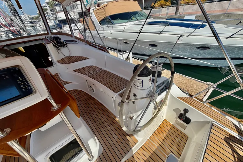 Slide: The Image of Cockpit of 2007 Jeanneau Sun Odyssey 42 DS sailboat with wooden deck and steering wheel. - 34