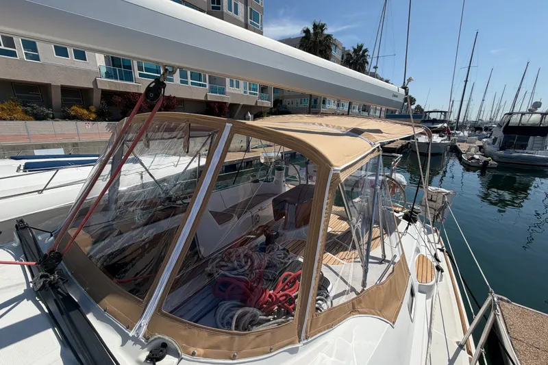 Slide: The Image of 2007 Jeanneau Sun Odyssey 42 DS sailboat docked at marina with tan canopy. - 13