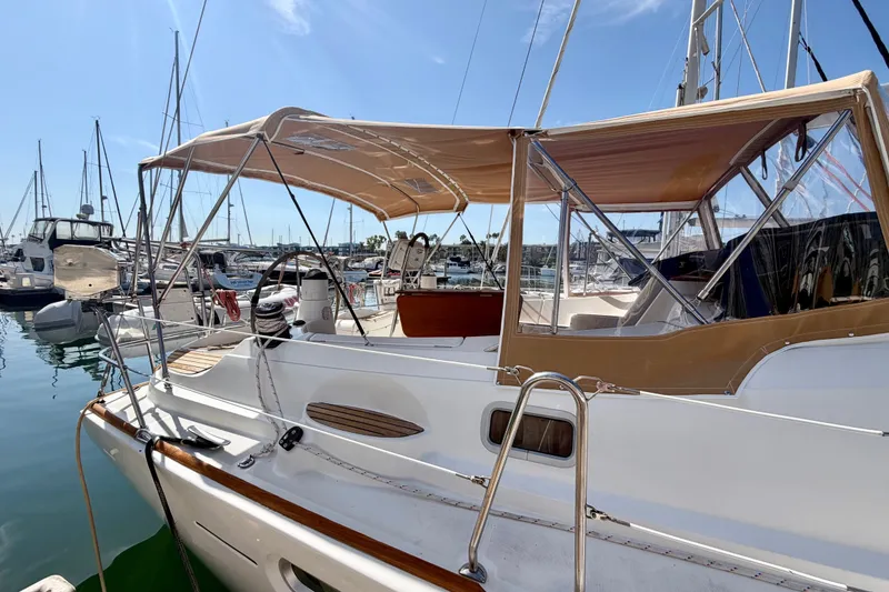 Slide: The Image of 2007 Jeanneau Sun Odyssey 42 DS sailboat docked in marina, featuring tan canopy. - 3
