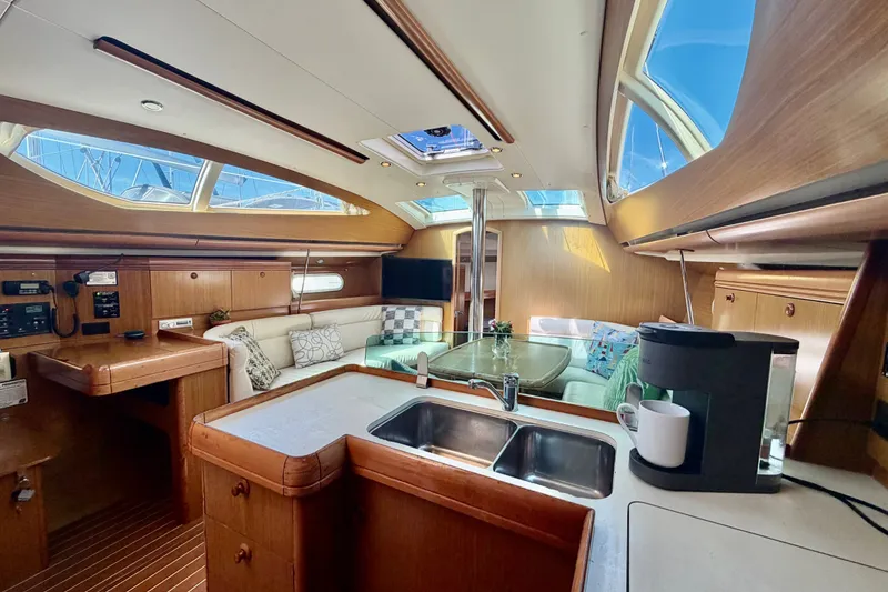 Slide: The Image of Interior of 2007 Jeanneau Sun Odyssey 42 DS yacht with modern kitchen and seating area. - 96