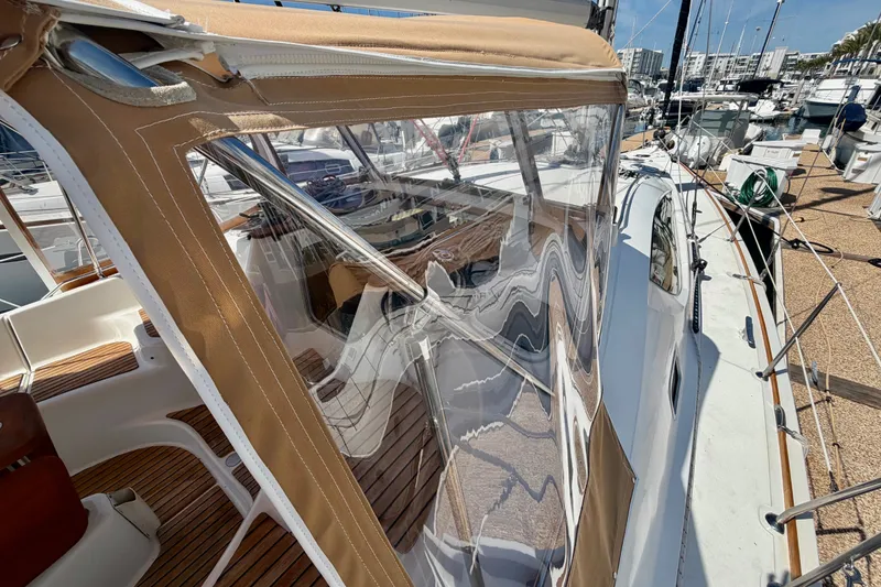 Slide: The Image of 2007 Jeanneau Sun Odyssey 42 DS sailboat with tan canvas enclosure in marina. - 4
