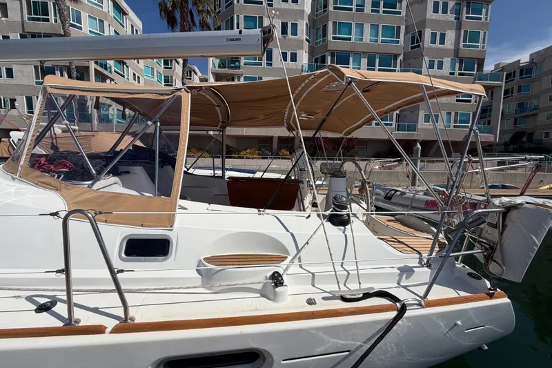 Slide: The Image of 2007 Jeanneau Sun Odyssey 42 DS sailboat docked near modern apartments. - 16