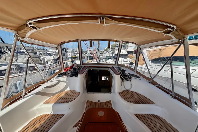 Slide: The Image of 2007 Jeanneau Sun Odyssey 42 DS cockpit with tan canopy, docked at marina. - 27