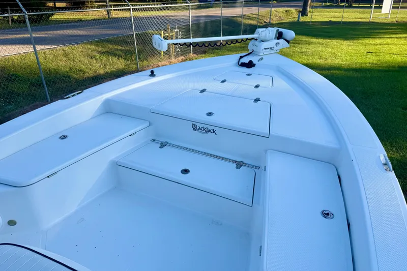 Slide: The Image of 2012 BlackJack 224 boat deck with storage compartments and trolling motor. - 3