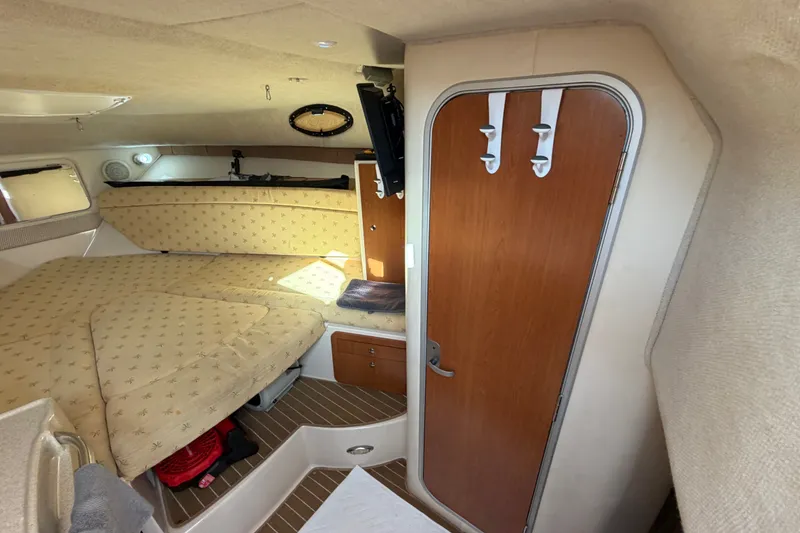 Slide: The Image of Interior cabin of 2005 Wellcraft 290 Coastal boat with cozy bed and wooden door. - 36