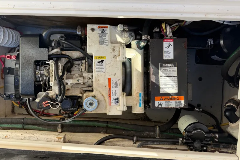 Slide: The Image of Engine compartment of a 2005 Wellcraft 290 Coastal boat, featuring a Kohler generator. - 53
