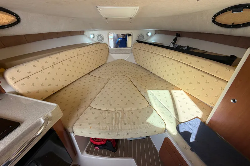 Slide: The Image of Interior cabin of 2005 Wellcraft 290 Coastal boat with beige cushioned seating. - 38