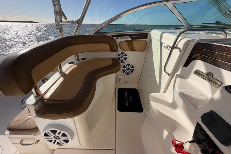 Slide: The Image of 2005 Wellcraft 290 Coastal boat interior with brown seating and ocean view. - 32