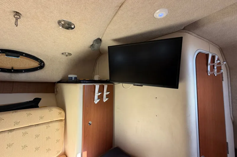 Slide: The Image of Interior of 2005 Wellcraft 290 Coastal boat with mounted TV and storage cabinets. - 49