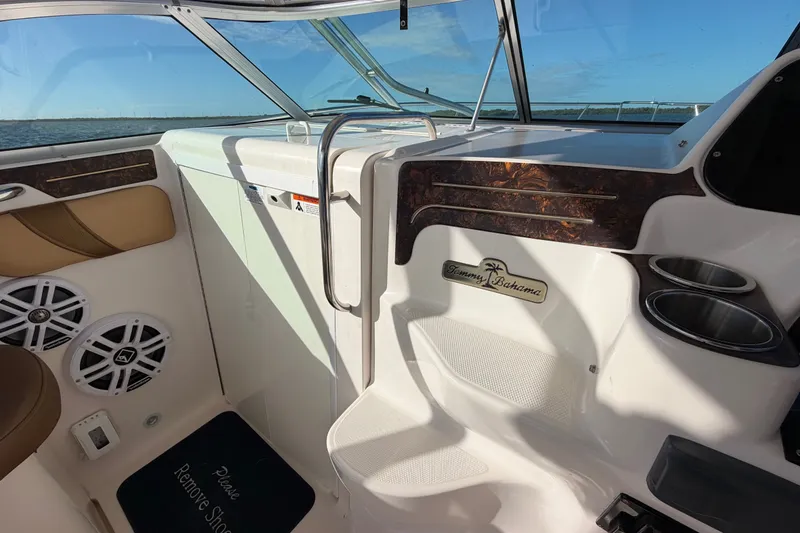 Slide: The Image of 2005 Wellcraft 290 Coastal boat interior with Tommy Bahama branding, cup holders, and speakers. - 34