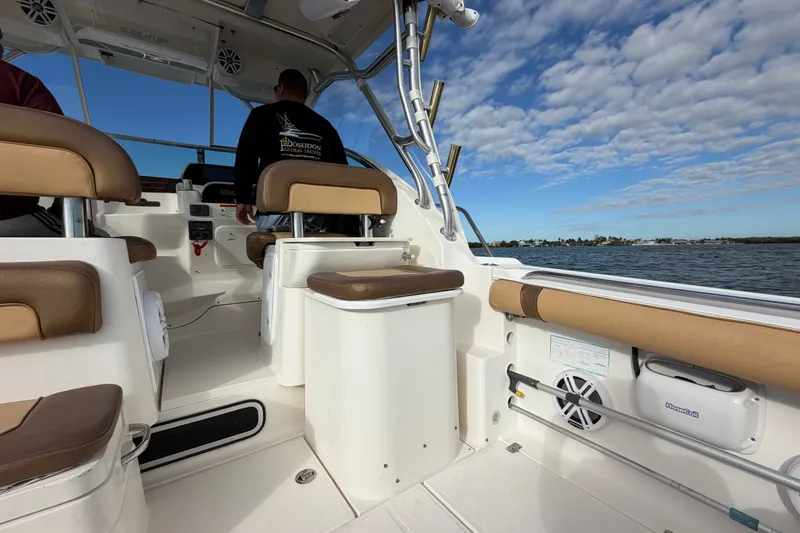 Slide: The Image of 2005 Wellcraft 290 Coastal boat interior with seating, steering, and ocean view. - 19