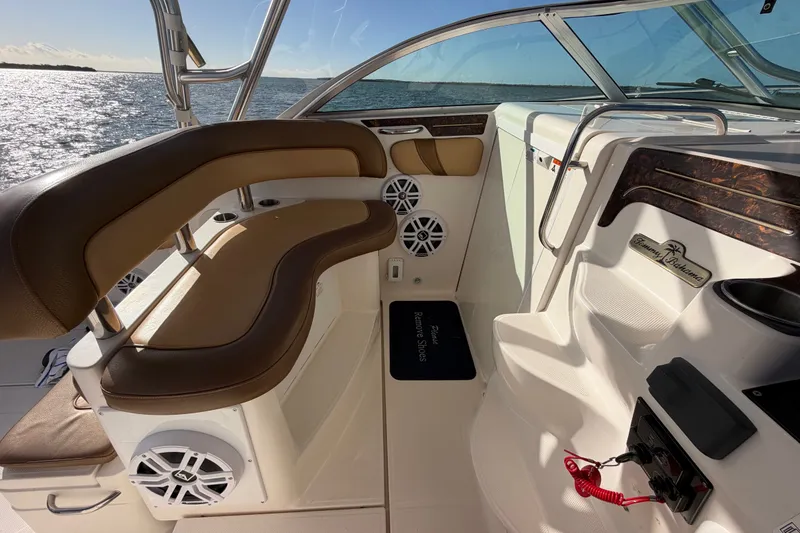 Slide: The Image of 2005 Wellcraft 290 Coastal boat interior with brown seating and ocean view. - 33