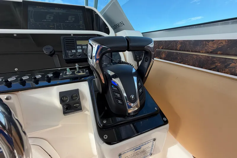 Slide: The Image of Control panel of a 2005 Wellcraft 290 Coastal boat with dual throttle levers. - 29