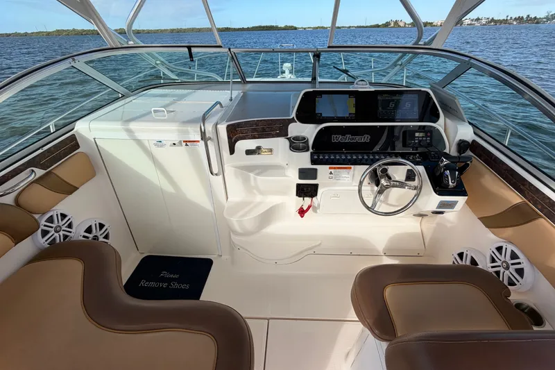 Slide: The Image of 2005 Wellcraft 290 Coastal boat interior with helm, steering wheel, and navigation equipment. - 25
