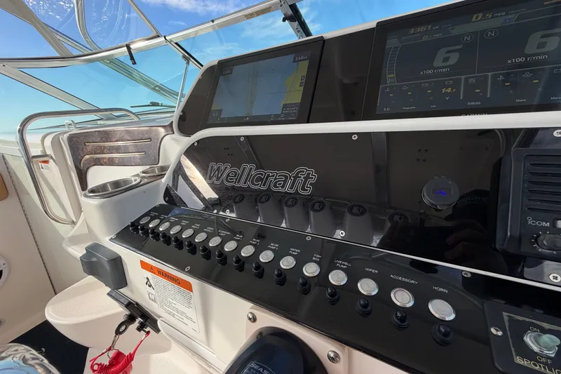 Slide: The Image of Control panel of a 2005 Wellcraft 290 Coastal boat with navigation displays. - 28