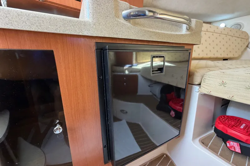 Slide: The Image of Interior of 2005 Wellcraft 290 Coastal boat with compact fridge and seating area. - 39